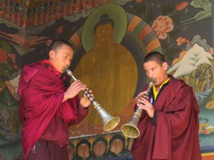 Monks playing trumphets